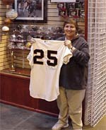 Carol and her prized game-used Barry Bonds 551st home run jersey