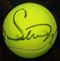 A tennis ball autographed by Serena Williams.