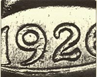 The recessed lines that extend from the lower right of the <i>9</i> are <br>the principal characteristics for certain counterfeit detection.