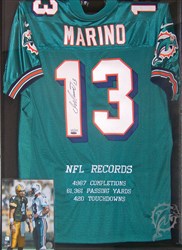 Michelin’s home décor is made up of signed jerseys and 8x10 photos, including this presentation of Dan Marino items.